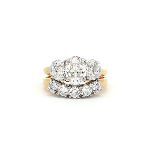 Oval Cut Three Stone Ring and Five Stone Curved Band in Yellow