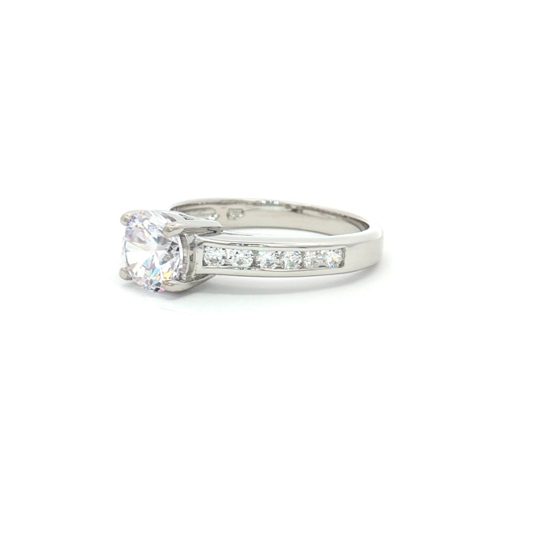 Petite Brilliant Cut Solitaire Ring with Princess Cut Channel Setting