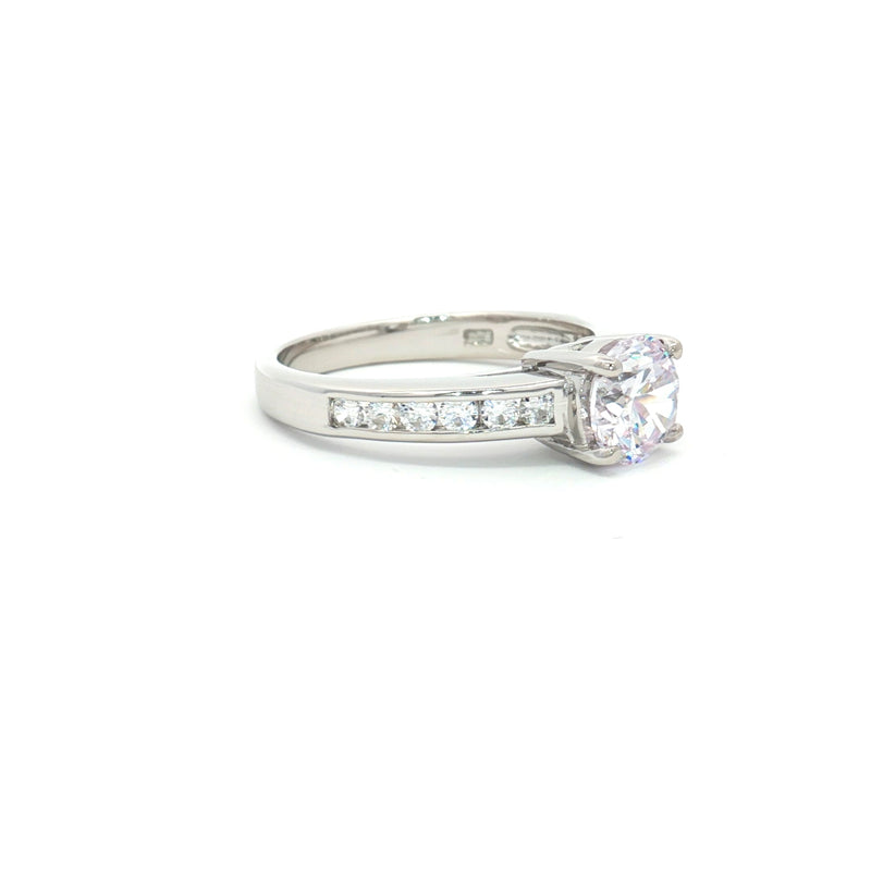 Petite Brilliant Cut Solitaire Ring with Princess Cut Channel Setting