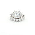 Radiant Cut Ring with Two Trillion Side Stones and Five Stone Curved Band