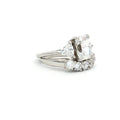 Radiant Cut Ring with Two Trillion Side Stones and Five Stone Curved Band