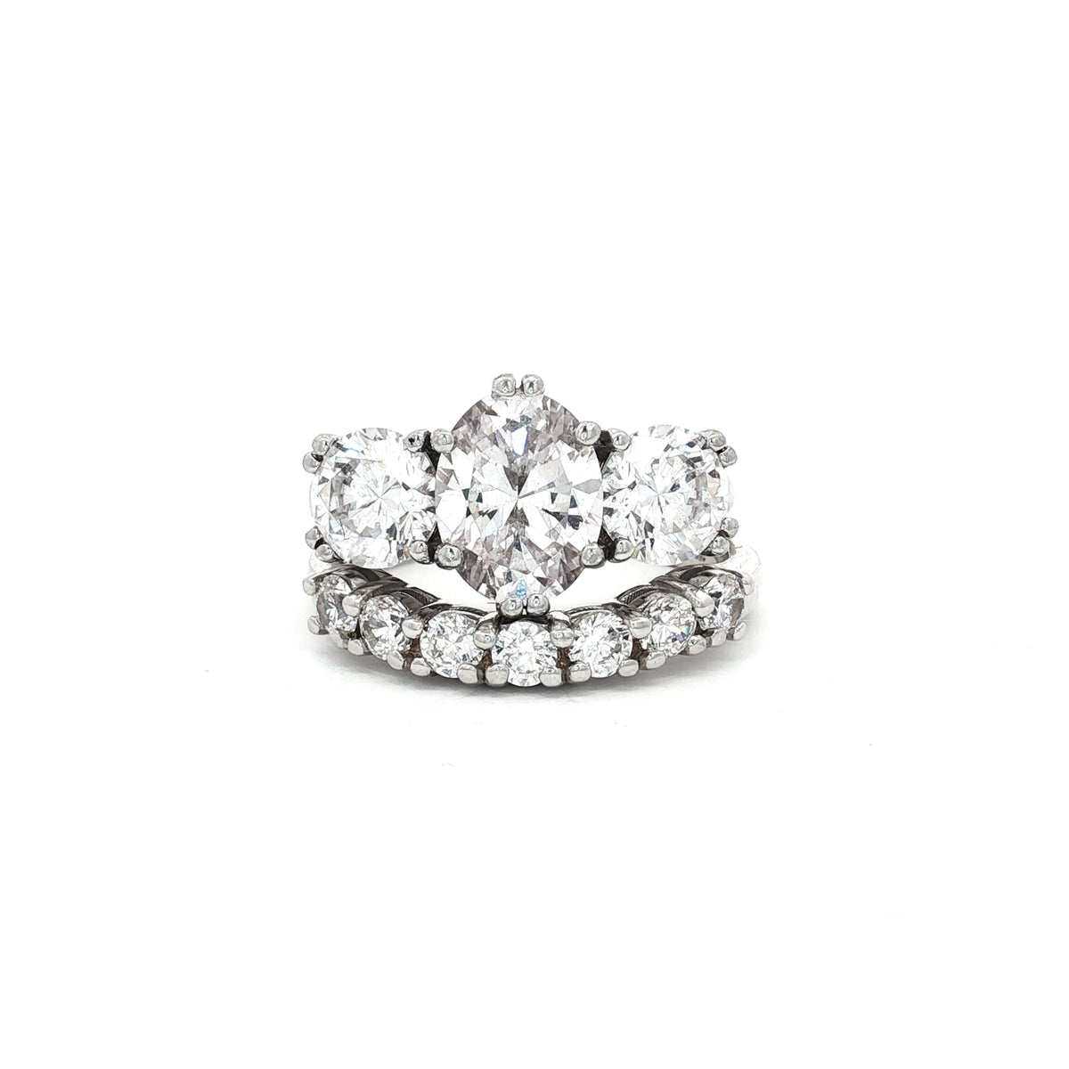 Oval Cut Ring with Two Brilliant Side Stones and Seven Stone Curved Band