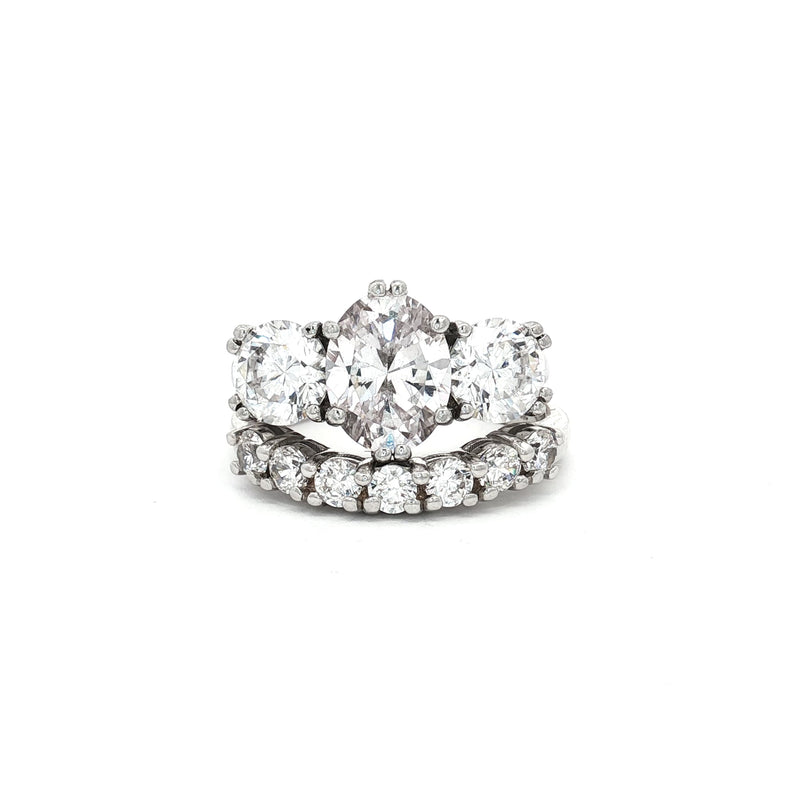 Oval Cut Ring with Two Brilliant Side Stones and Seven Stone Curved Band