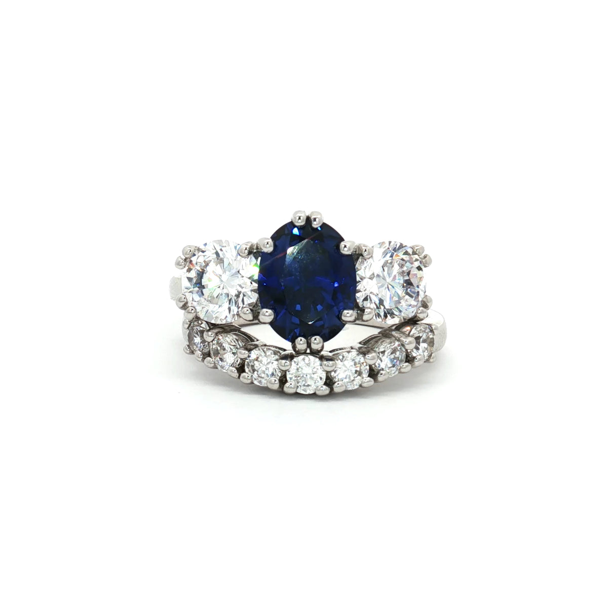 Oval Cut Sapphire  Ring with Two Brilliant Side Stones and Seven Stone Curved Band