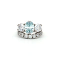 Oval Cut Aqua Marine Ring with Two Brilliant Side Stones and Seven Stone Curved Band