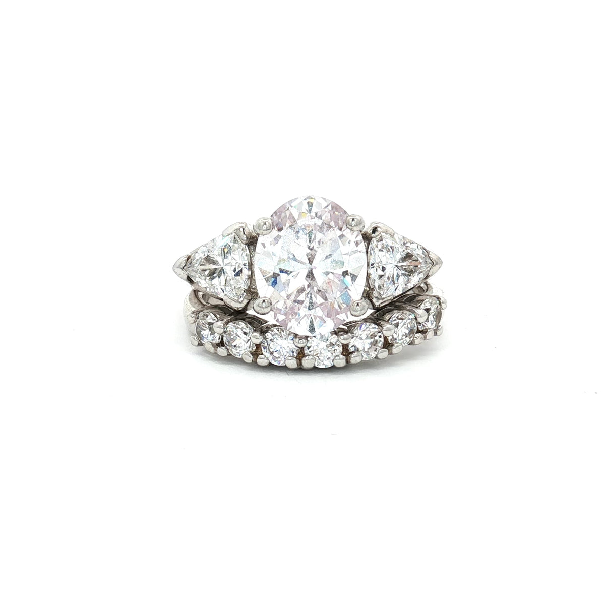 Oval Cut Ring with Trillion Side Stones and Seven Stone Curved Band