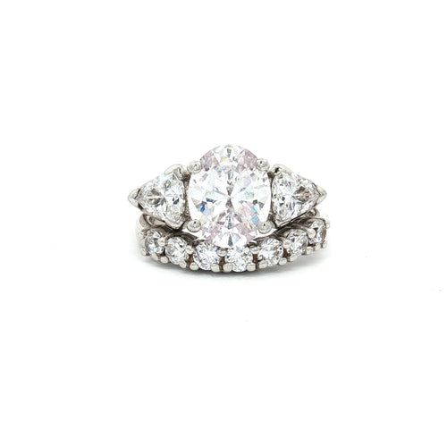 Oval Cut Ring with Trillion Side Stones and Seven Stone Curved Band