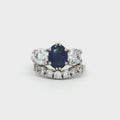 Oval Cut Sapphire  Ring with Two Brilliant Side Stones and Seven Stone Curved Band