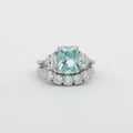 Radiant Cut Aqua Marine  Ring with Two Trillion Side Stones and Five Stone Curved Band