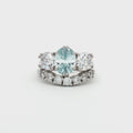 Oval Cut Aqua Marine Ring with Two Brilliant Side Stones and Seven Stone Curved Band